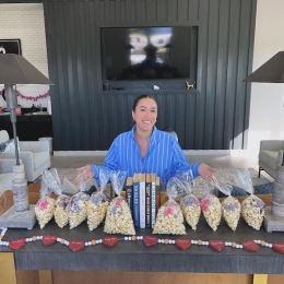 a woman smiling and sitting at a table